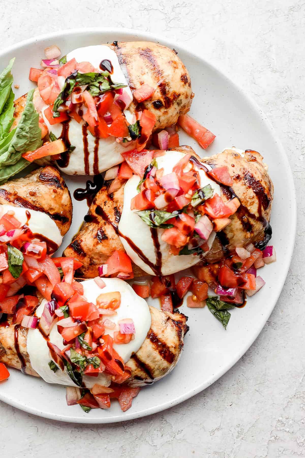 Bruschetta chicken topped with mozzarella, tomato, and a balsamic glaze drizzle. 