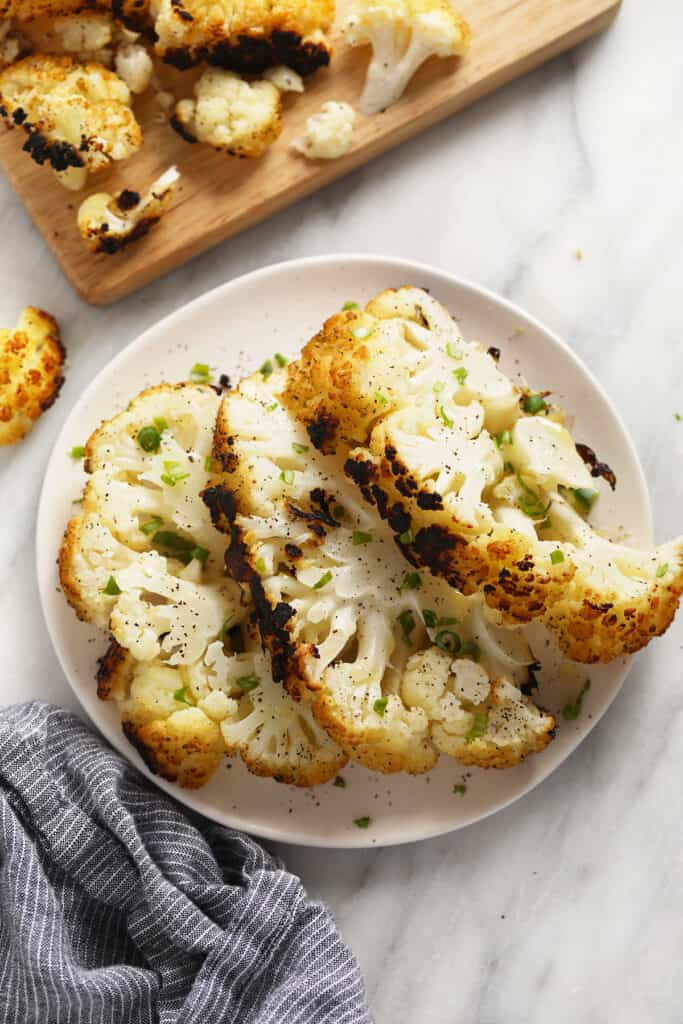A plate of grilled cauliflower steaks. 