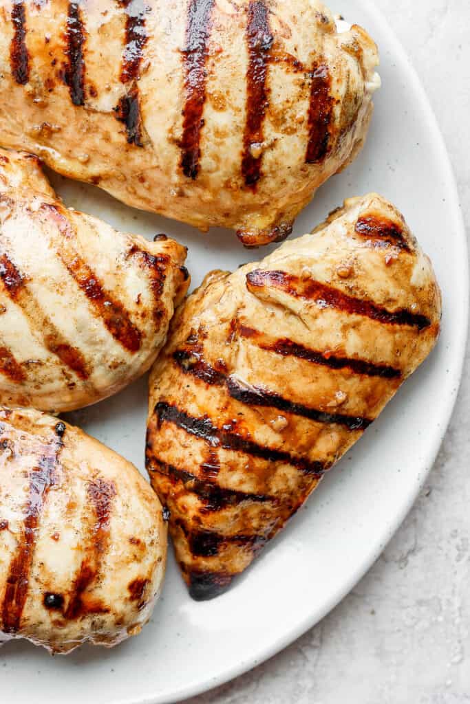 Grilled chicken breasts on a plate. 