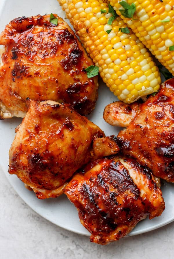 grilled chicken and corn on a plate.