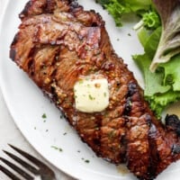 grilled steak on plate with butter