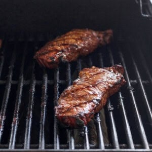 grilling steak on grill.