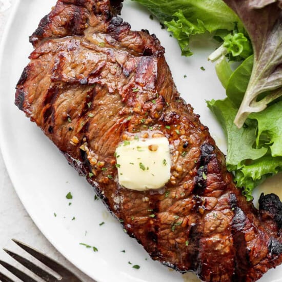 grilled steak with butter on plate