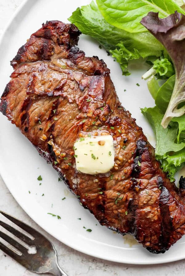 grilled steak with butter on plate