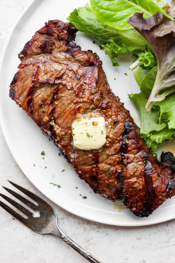 steak on plate with butter.