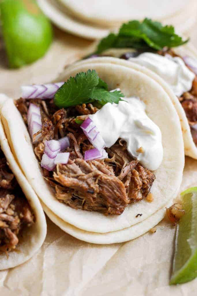 Carnitas tacos on a plate. 