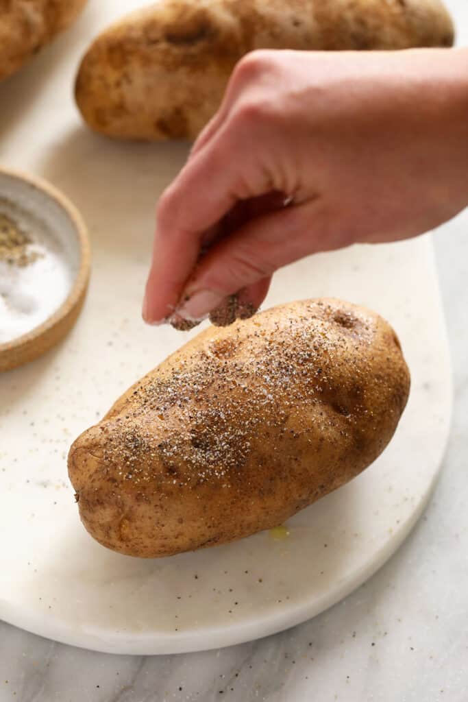 salt and pepper on baked potato
