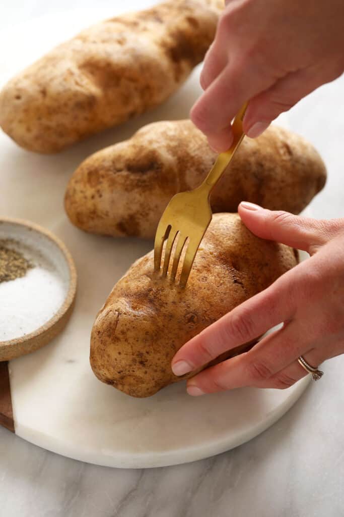 poking hole in baked potato with fork
