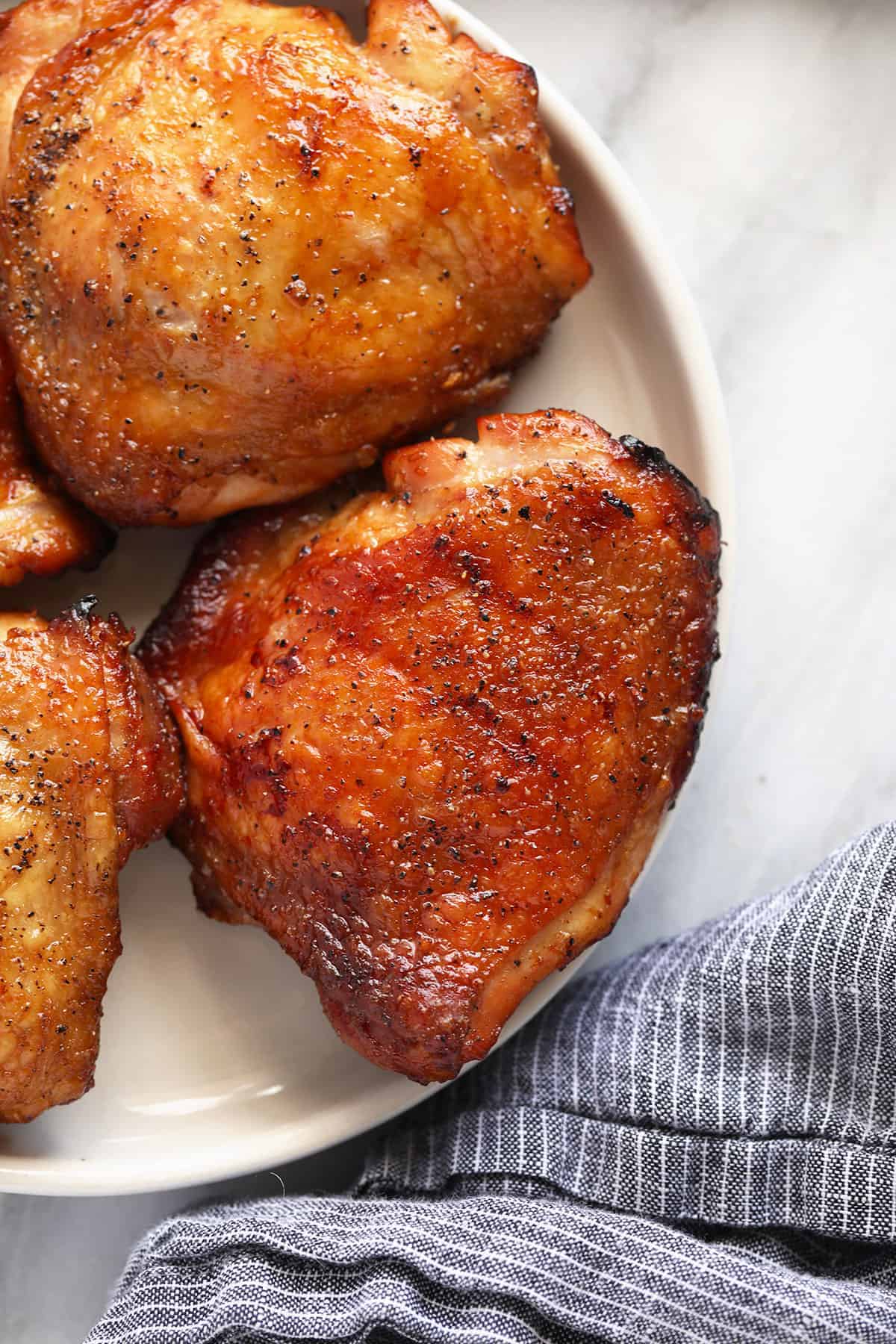 Smoked chicken thighs on a plate. 