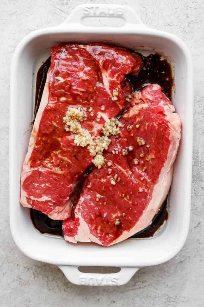 Marinate steaks in casserole dish.