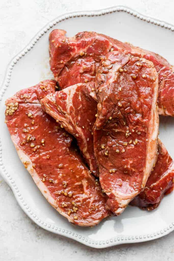 marinated steaks on the plate.