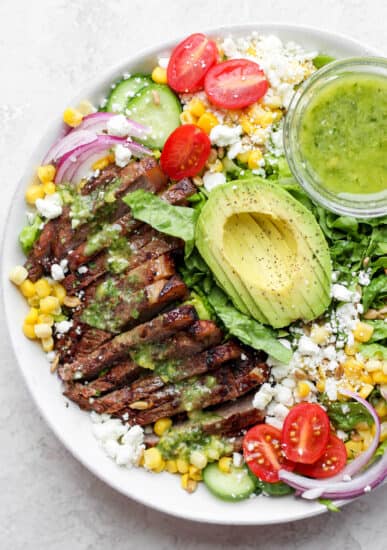 steak salad in bowl with dressing