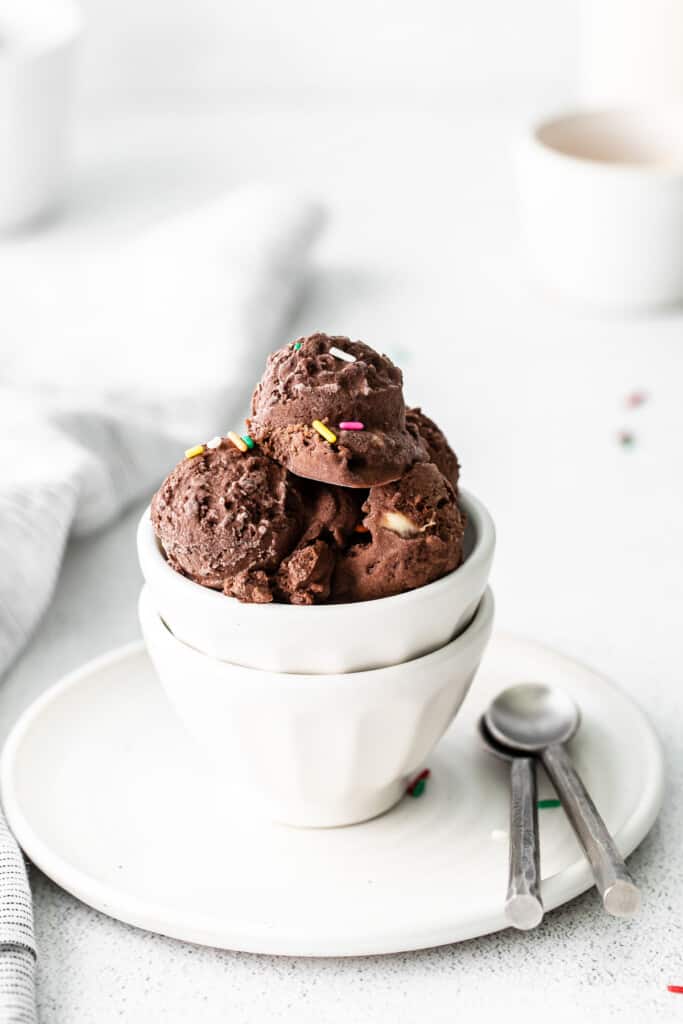 three scoops of chocolate protein ice cream in a bowl with sprinkles.