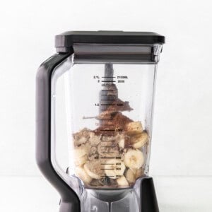 A blender filled with bananas and other ingredients.