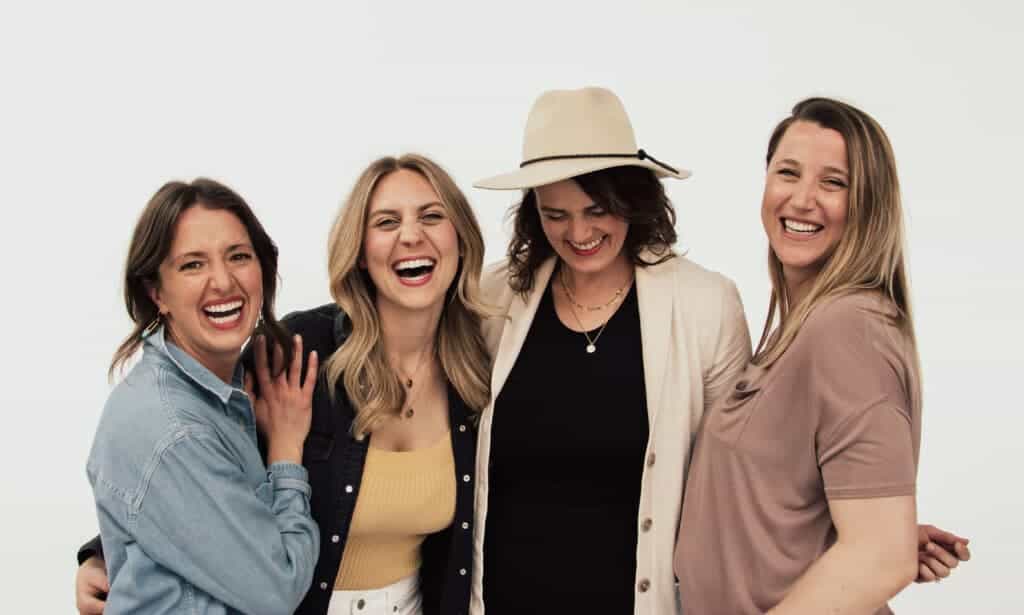 Four women wearing necklaces.