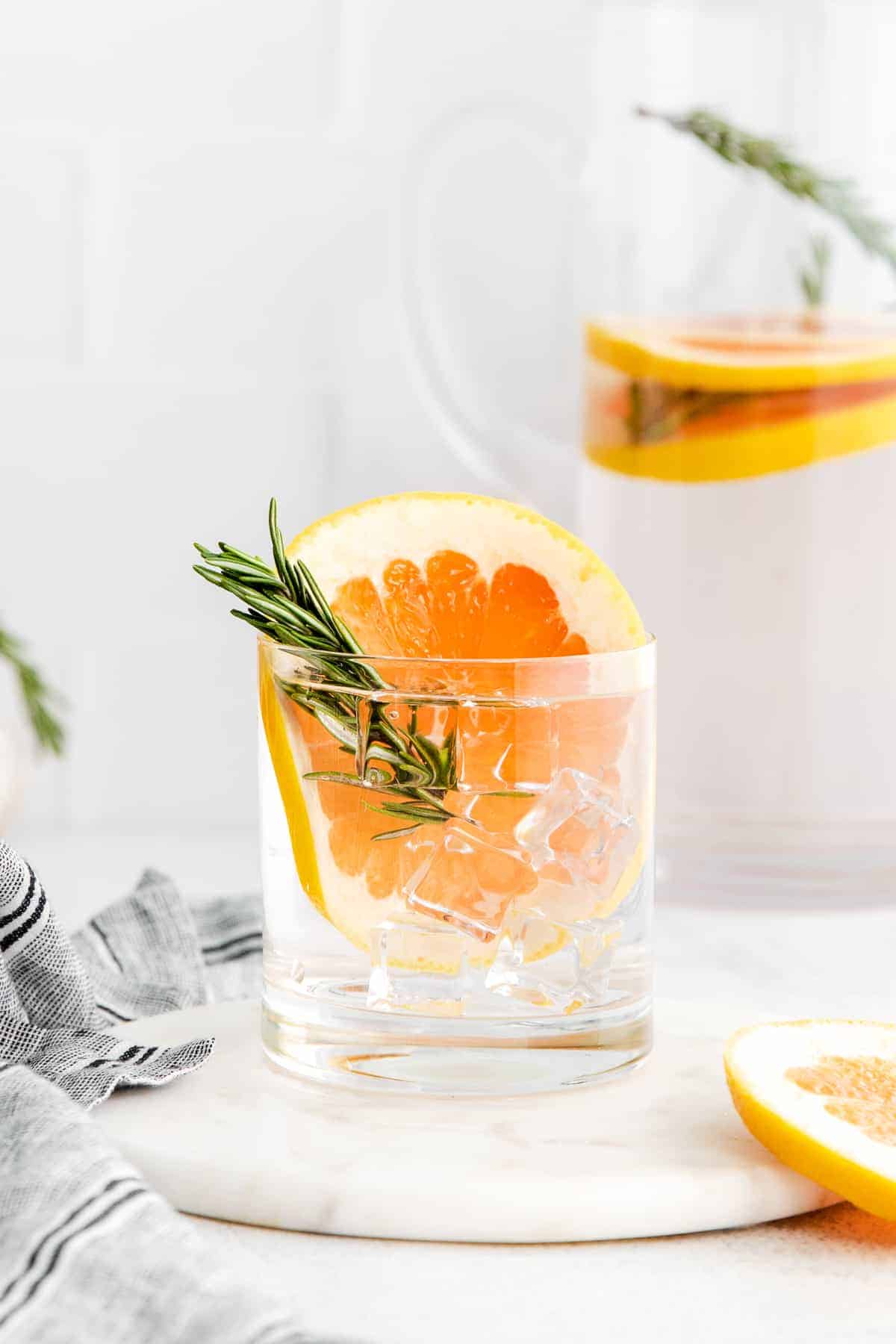 Grapefruit and rosemary infused water in glass.