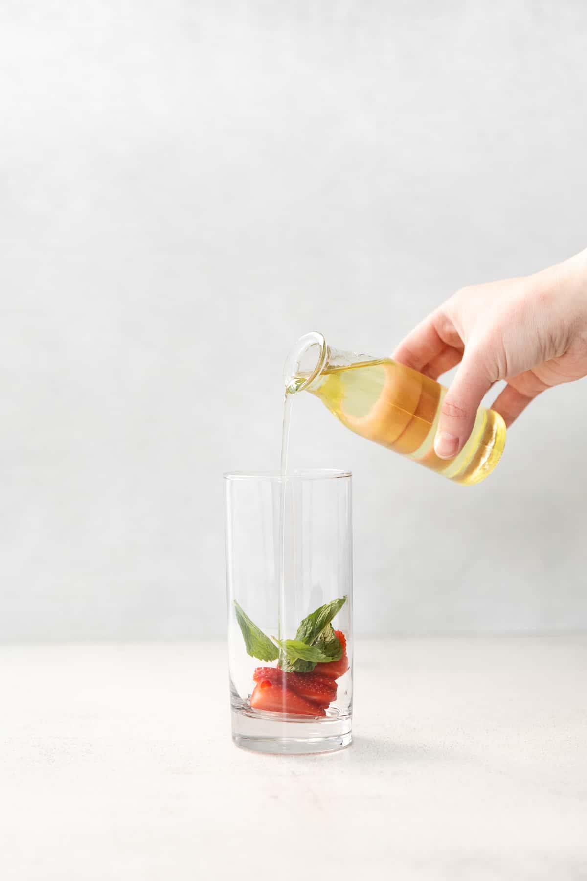 adding simple syrup to glass