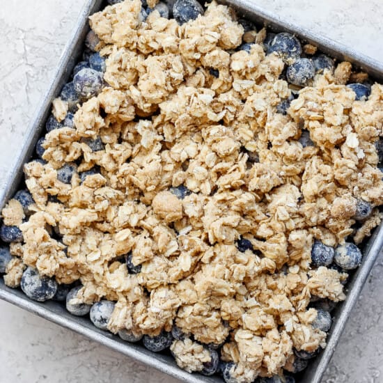 uncooked blueberry crisp in a baking dish.