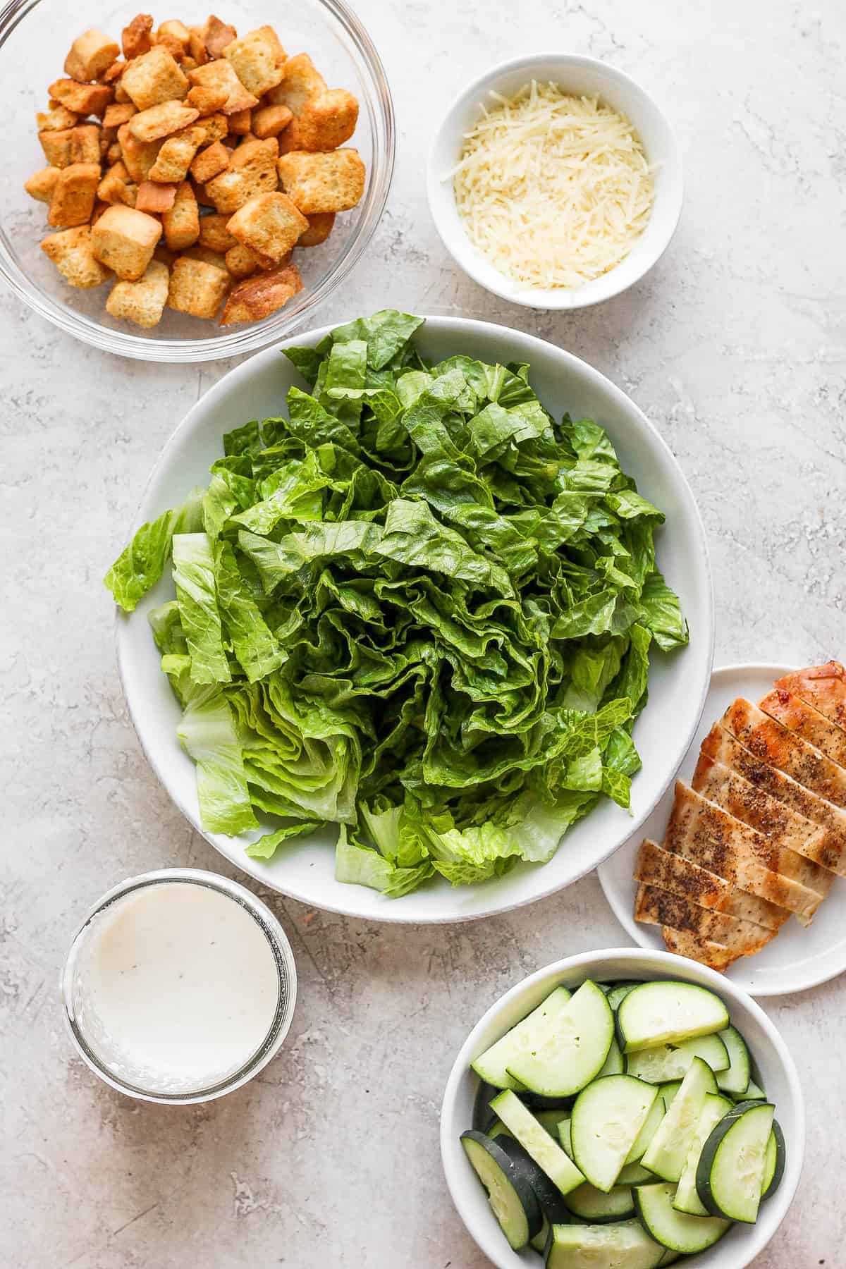 Chicken caesar salad ingredients in a bowl. 