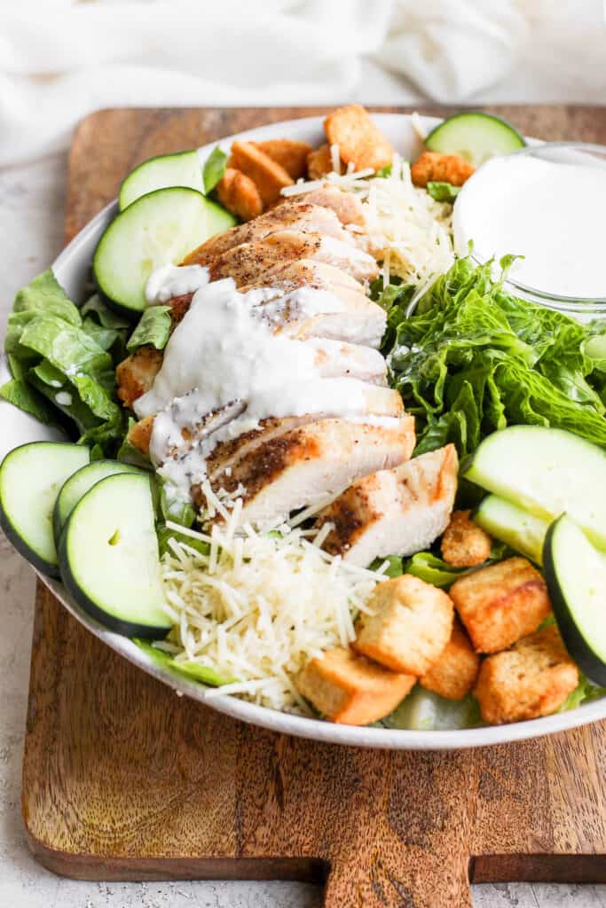 Chicken on top of a salad. 
