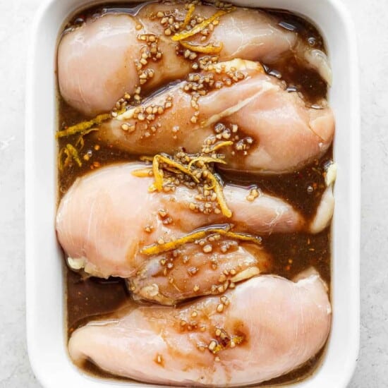chicken marinating in dish.
