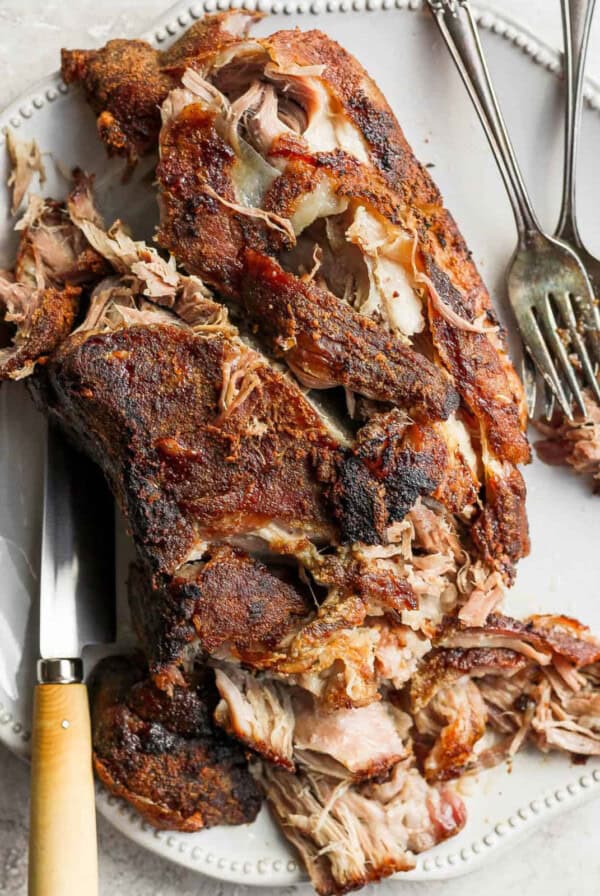 bbq pulled pork on a plate with a fork.