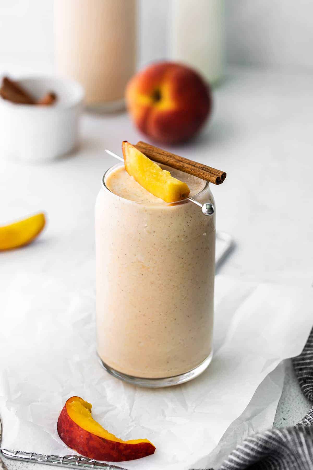 peach smoothie with fresh peach and cinnamon stick