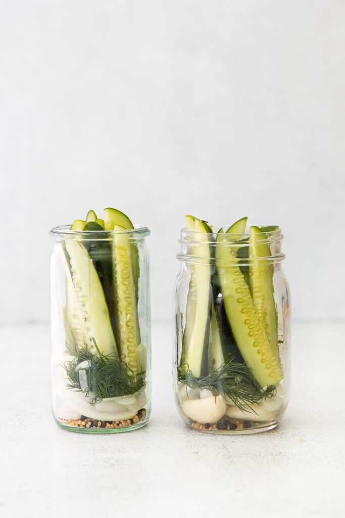 Refrigerator pickle ingredients in two mason jars. 