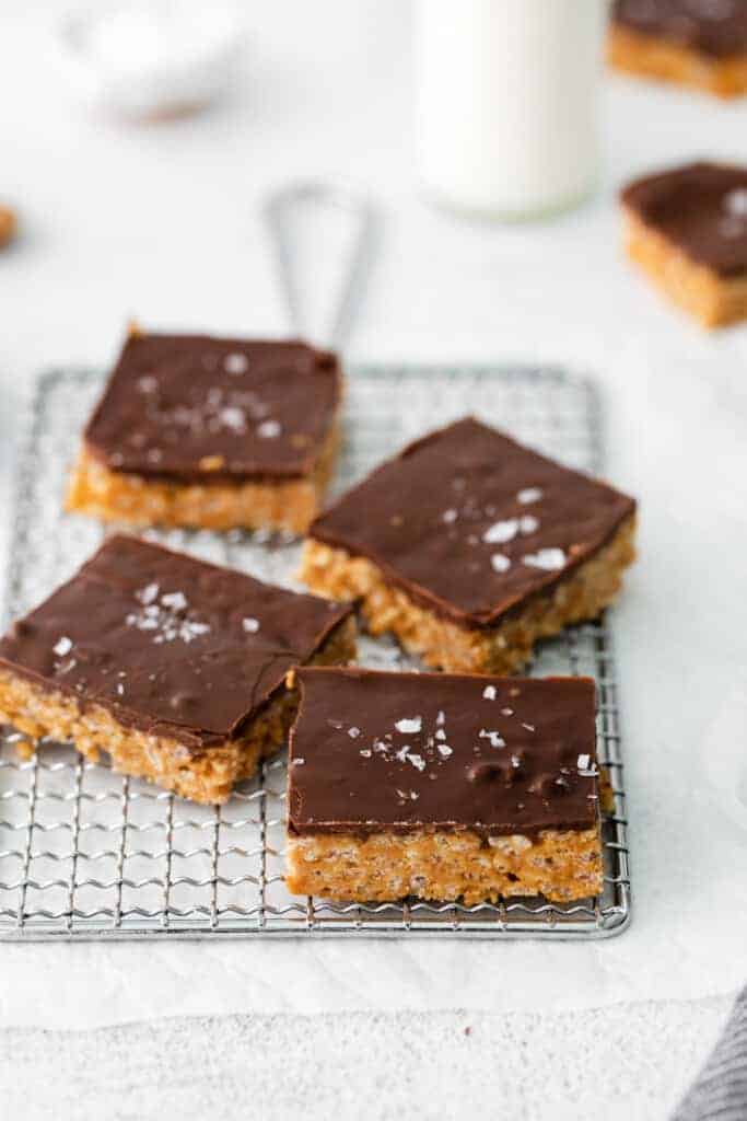 These healthy Scotcheroos are made with all-natural sugar, unsalted peanut butter, and coconut oil (no white sugar or corn syrup)! They're ready in no time and are a great healthy twist on this classic dessert bar. Sliced healthy Scotcheroos and topped with flaked sea salt