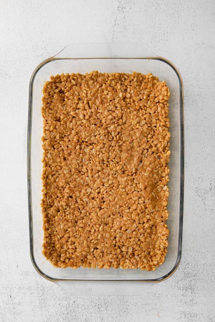 Rice crispy layer of healthy Scotcheroos in a casserole dish