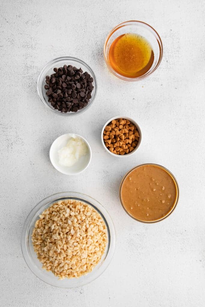 These healthy Scotcheroos are made with all-natural sugar, unsalted peanut butter, and coconut oil (no white sugar or corn syrup)! They're ready in no time and are a great healthy twist on this classic dessert bar. Ingredients for healthy Scotcheroos in small mixing bowls