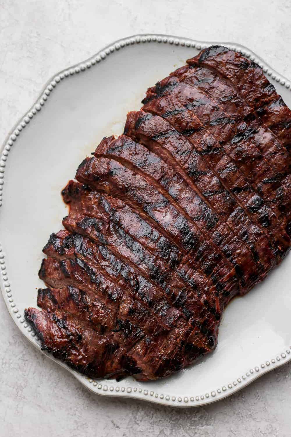 Sliced flank steak on a plate.