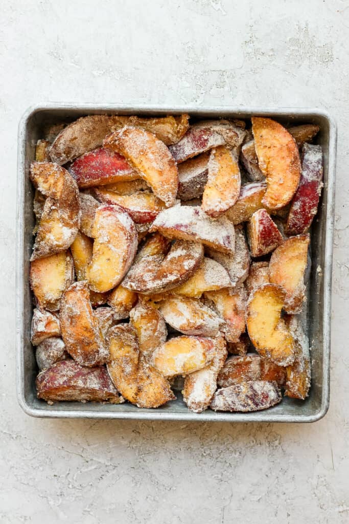 Peach crisp ingredients in a baking dish.