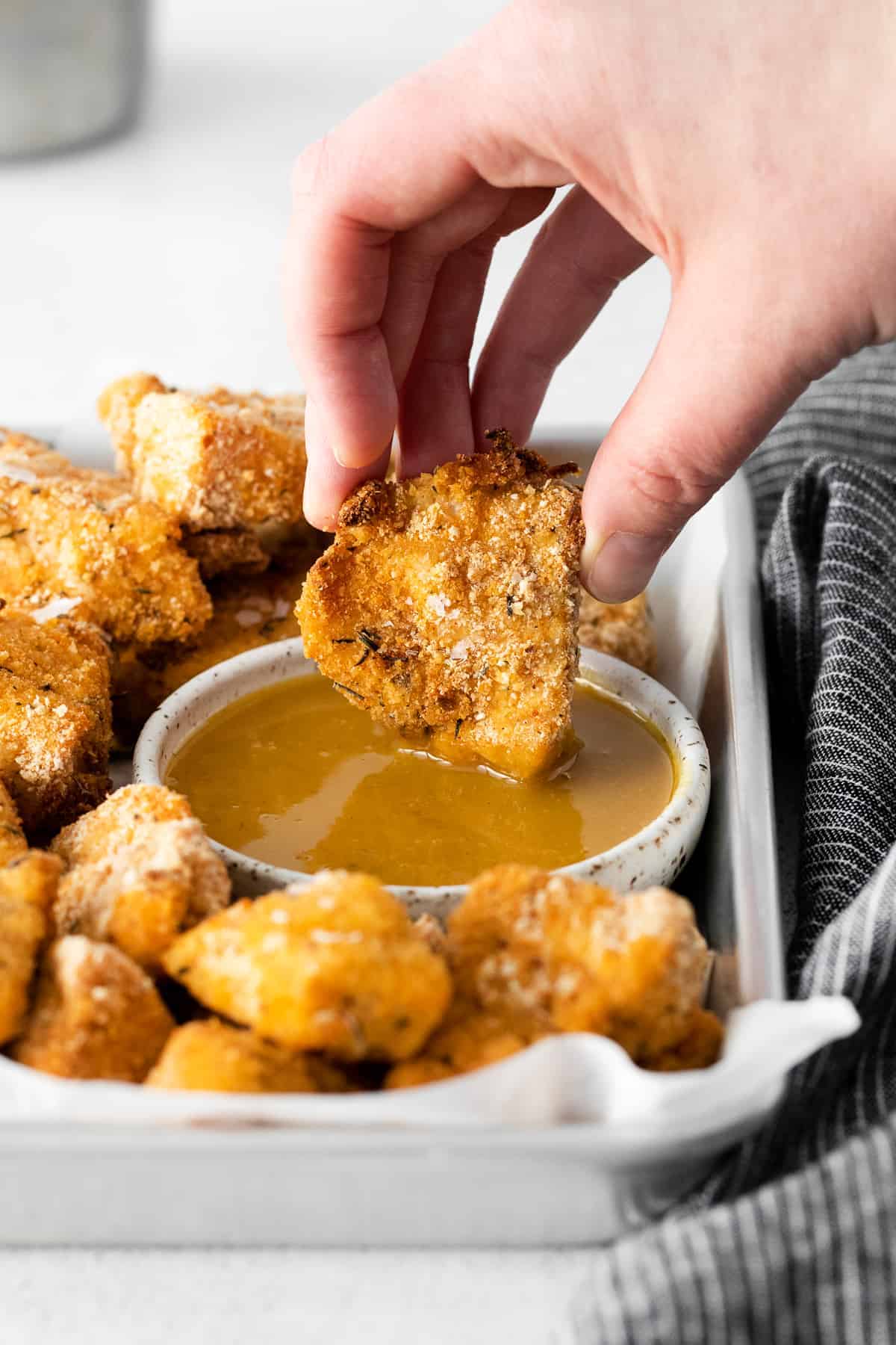 dipping chicken nuggets in honey mustard