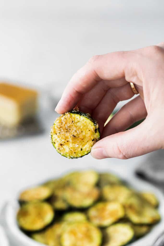 slice of air fryer zucchini in someone's hand.