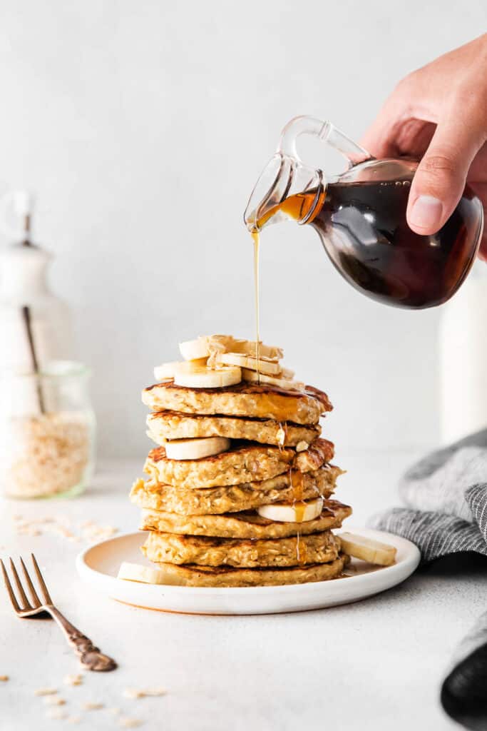 pouring syrup on pancakes