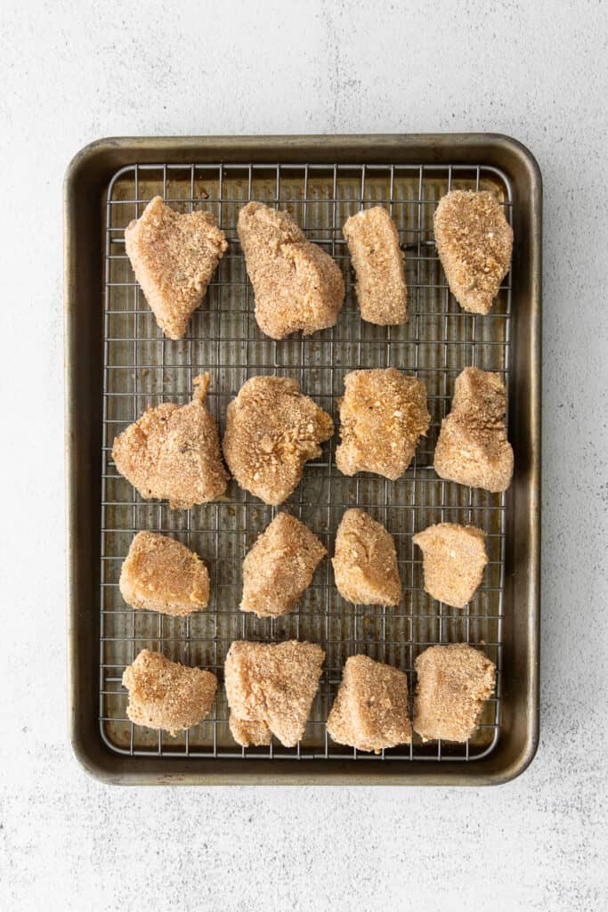 uncooked chicken nuggets on baking sheet