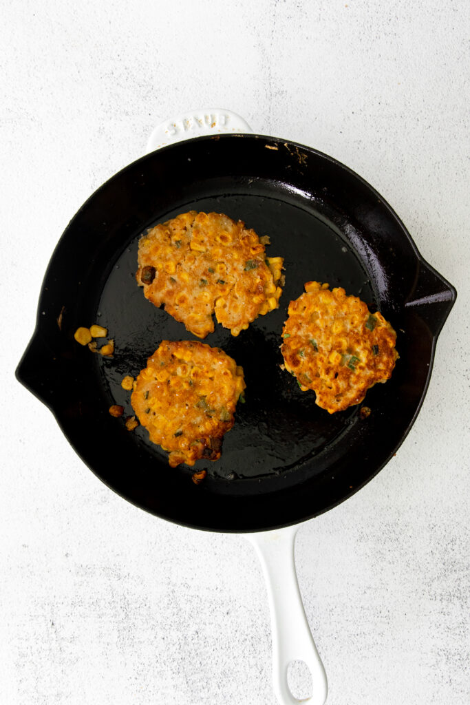 Crispy corn fritters in a cast iron pan. 