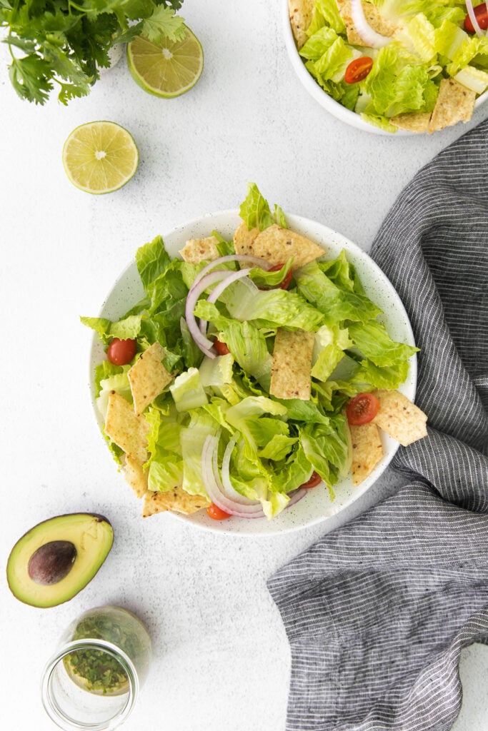 taco salad in a bowl, ready to be topped with beef taco meat