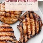 3 grilled pork chops on plate.