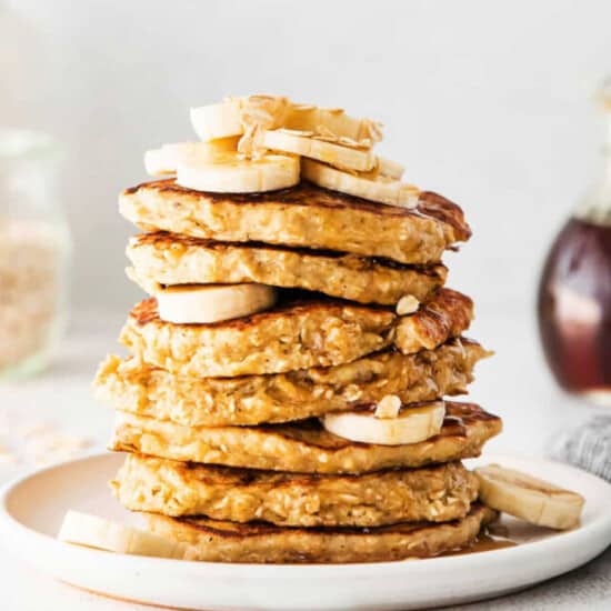A stack of oatmeal banana pancakes on a plate.