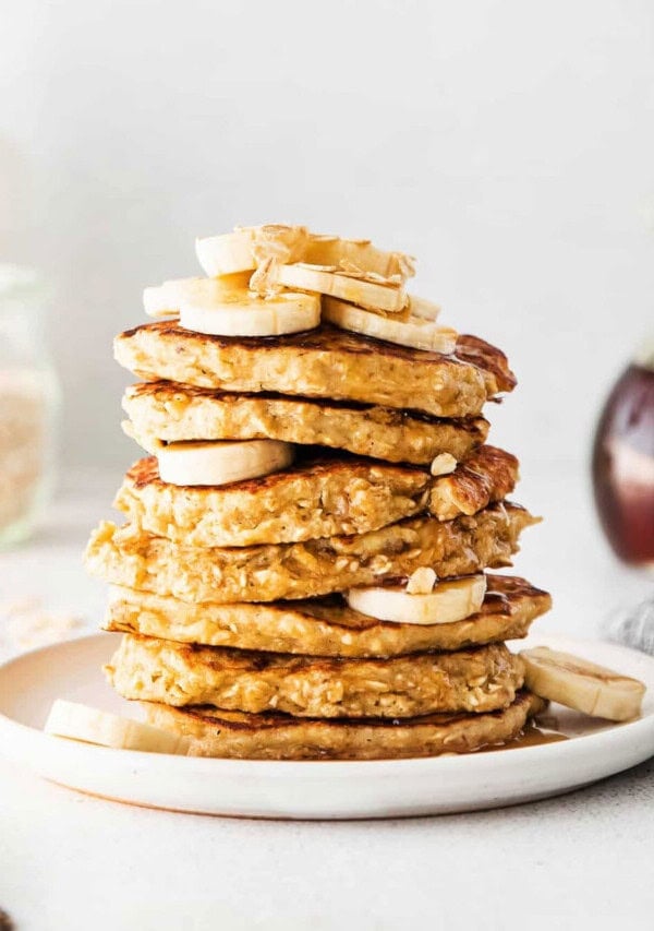 A stack of oatmeal banana pancakes on a plate.