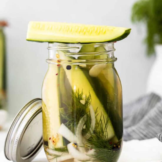 Pickled cucumbers in a mason jar.