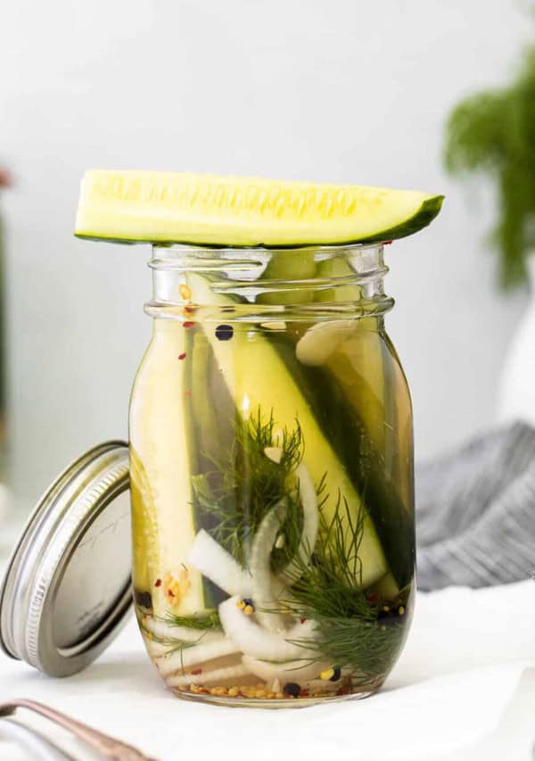 Pickled cucumbers in a mason jar.