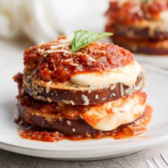 A stack of eggplant lasagna on a white plate.