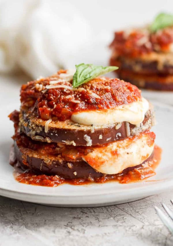 A stack of eggplant lasagna on a white plate.