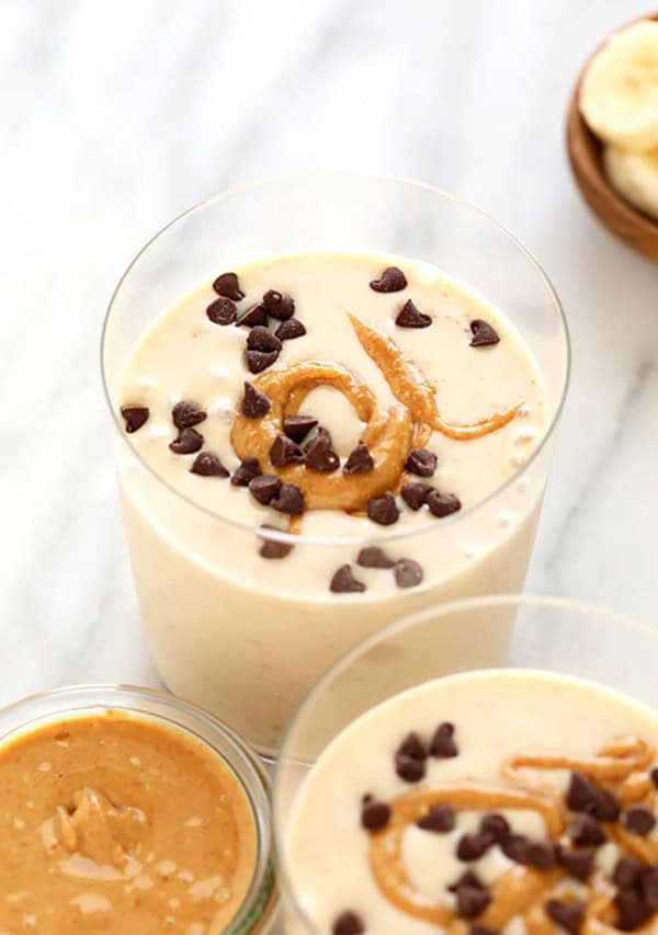 Two bowls of oatmeal with peanut butter and bananas.