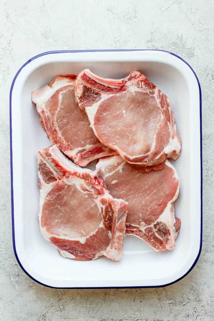 raw pork chops in dish