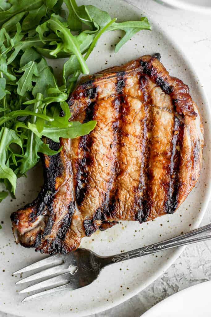 grilled pork chop on plate.