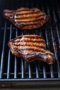 grilling pork chop on grill.